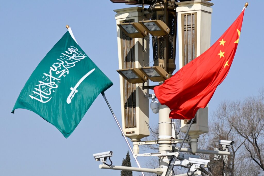 The Saudi and Chinese flag flying alongside each other. 