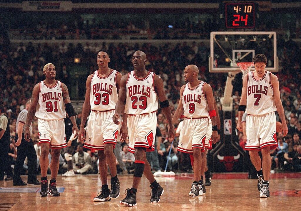 Michael Jordan leads his Chicago Bulls teammates off the basketball court. This rotation is the core of the Last Dance. From left to right: Dennis Rodman, Scottie Pippen, Michael Jordan, Ron Harper, and Toni Kukoč.
