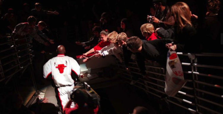 Michael Jordan runs out of the Chicago Bulls tunnel and is cheered on by fans