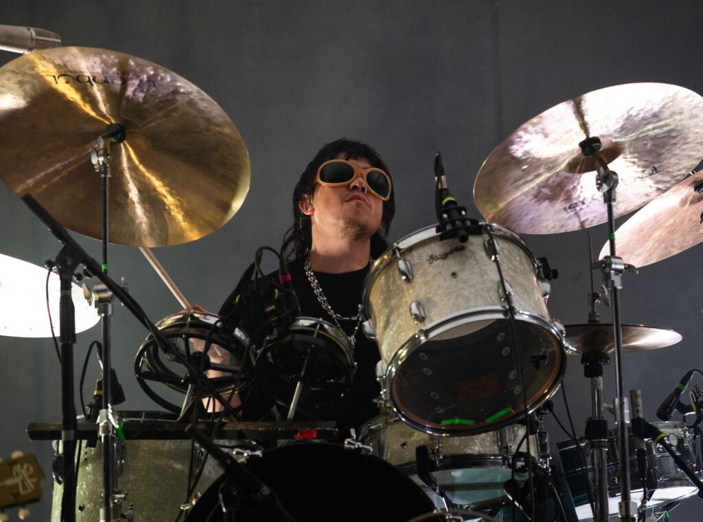 Max Bassin drumming during Austin, Texas show.